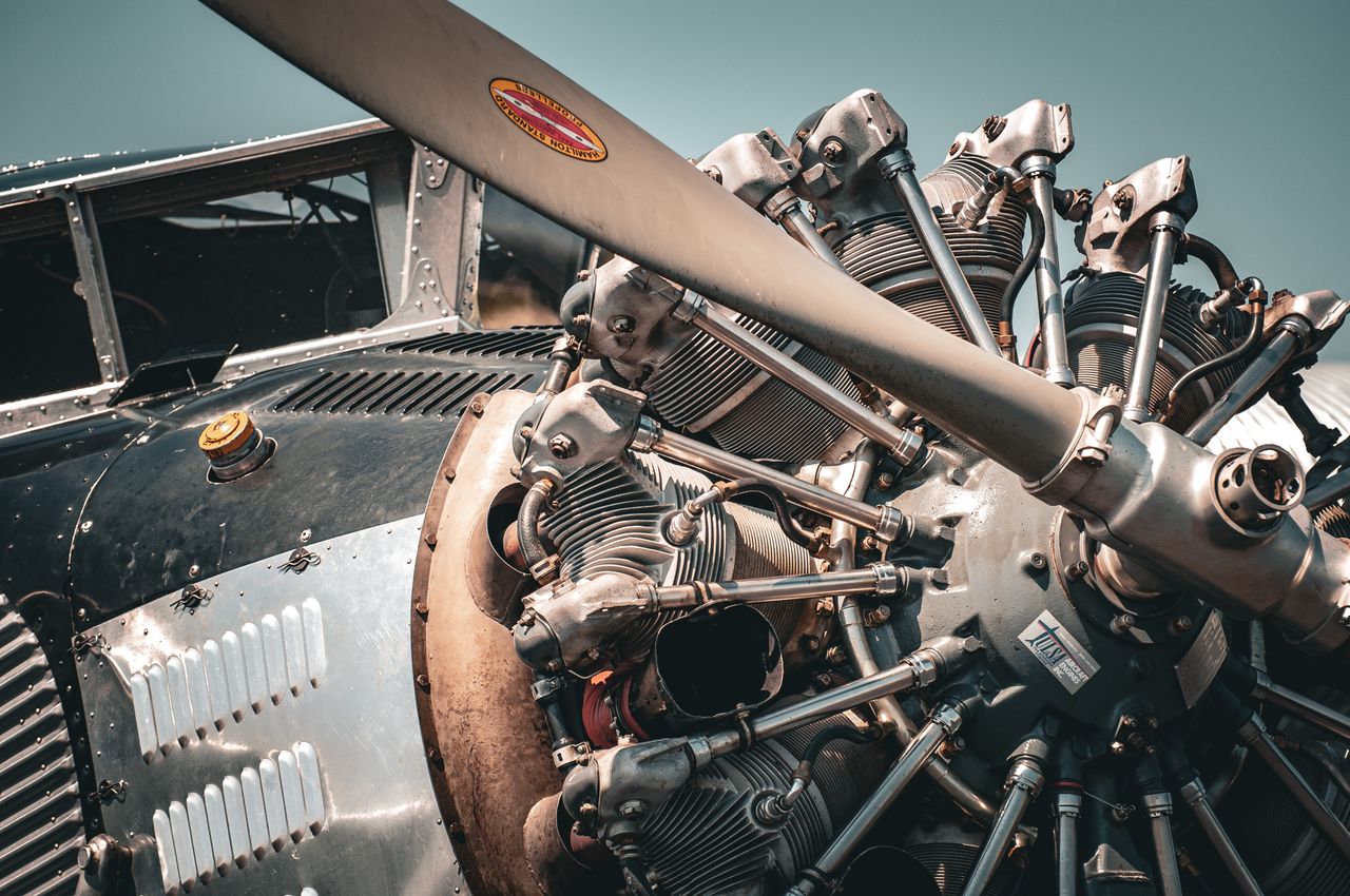 Detailed view of a vintage aircraft engine and propeller showcasing intricate mechanical design.